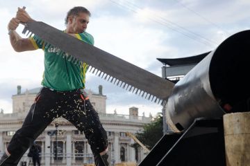 Person competes in a wood chopping competition to illustrate enmark cuts undergraduate numbers but aims for overseas growth
