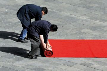 wo workers of the Mexican National Palace, roll a red carpet to illustrate Tec de Monterrey splashes out $100 million on top Western scholars