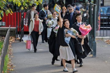 An Asian graduate from Imperial College London holds a Lego aircraft model to illustrate Public wary of growing overseas student numbers as views shift