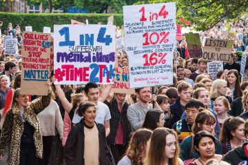 Student protest demanding better mental health services to illustrate Only legislation can address patchy practice on suicide prevention