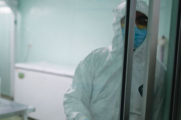  A health worker closes  the door of a laboratory as a metaphor for Many postdoctoral researchers in the UK are suffering in silence because they feel unable to report discriminatory microaggressions