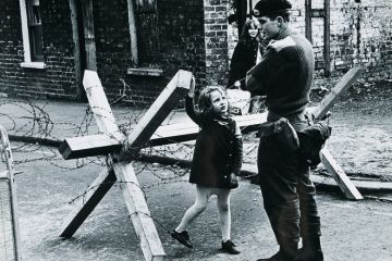 A young girl talking to a British soldier manning a roadblock on a street in Belfast, Northern Ireland during The Troubles, summer 1973 A young girl talking to a British soldier manning a roadblock on a street in Belfast, Northern Ireland during The Troubles, summer 1973
