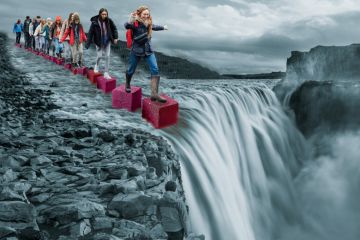 Montage of a group stepping on cubes leading to a waterfall Montage of a group stepping on cubes leading to a waterfall