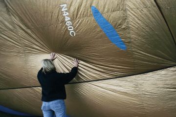 Person inflates hot air balloon to illustrate Legal pressure from Free Speech Union forces Essex policy revisions