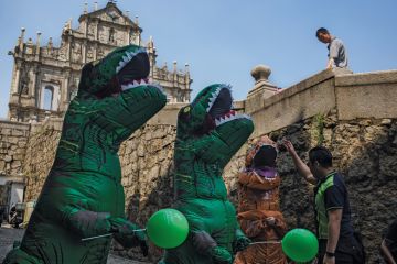A man interacts with workers dressed in dinosaur costumes at the Ruins of St. Paul's Cathedral in Macau, China A man interacts with workers dressed in dinosaur costumes at the Ruins of St. Paul's Cathedral in Macau, China to illustrate University leaders ‘need to be better prepared for tough times’
