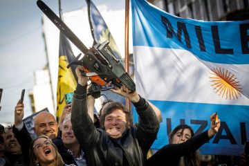Presidential candidate Javier Milei of La Libertad Avanza lifts a chainsaw next to Buenos Aires province governor candidate