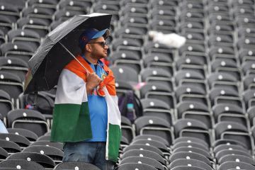 A fan shelters from the rain with an umbrella amongst empty seats as play is delayed during the Semi-Final match of the ICC Cricket World Cup 2019 between India and New Zealand to illustrate ‘Tough year’ for UK international student recruitment