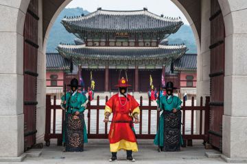 Guards of Gyeongbokgung stand at the closed gates of the palace to illustrate Korean universities hit with overseas recruitment bans