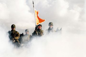 Dutch cavalry horses and their riders are exposed to smoke s they undergo a stress test on the beach in Scheveningen to illustrate English-language teaching under pressure ahead of Dutch election