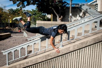A lady vaults over a stair railing as a metaphor for a quarter of US states ‘likely to skip’ Biden free college plan