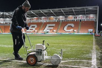 Ground staff paints the white lines of the football pitch in Blackpool to illustrate What can academics and universities learn from Jo Phoenix’s employment tribunal victory