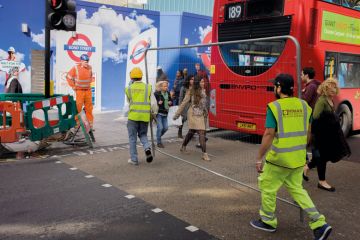 Workman carry a construction fence across Oxford Street in central London to illustrate Shift to relationship bans ‘signals new approach in universities’
