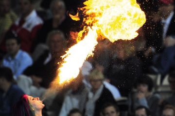 A fire-eater entertains the crowd to illustrate Australian international education blows hot and cold