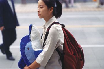 Chinese lady holding toy whale