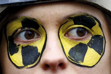 Close up of face with eyes painted circles yellow and black 