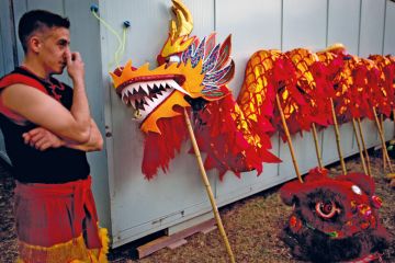 A dancer stands next to a dragon held up with poles in Buenos Aires, Argentina to illustrate Fees for foreign students ‘a sign of what’s to come’ in Argentina