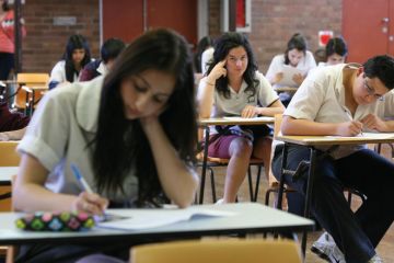 Students taking exams to illustrate Australian universities stick with ‘unfair’ early entry schemes