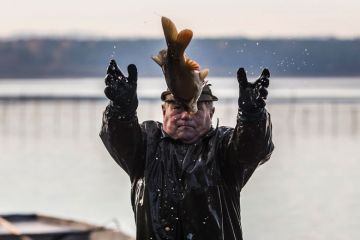  A fisherman catching a big fish to illustrate Delaware ecologist caught in fish research misconduct net