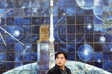 A man walks past a space mural depicting a rocket launch in Beijing, China to illustrate China’s Young Thousand Talents fails to attract ‘top’ scientists