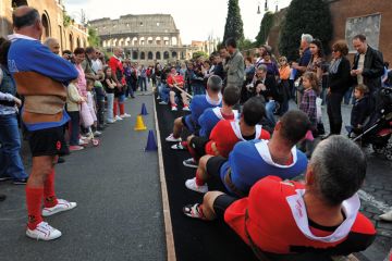 Traditional tug-of-war game near the ancient Colosseum in Rome to illustrate Italy mandates live delivery and staff ratios for online degrees