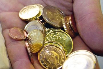 Hand full of Euro coins in Belgium to illustrate Ghent offers flat research grants 