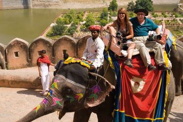 Tourists on holiday having colorful elephant rides at Amber Fort in Rajasthan Jaipur India to illustrate Southampton wants 5,000 students at ‘comprehensive’ India campus