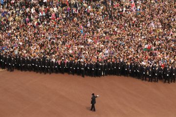 Well wishers surge along the Mall behind the police towards Buckingham Palace to celebrate the Royal Wedding of Prince William Well wishers surge along the Mall behind the police towards Buckingham Palace to celebrate the Royal Wedding of Prince William to illustrate Should student number caps be reinstated in England?