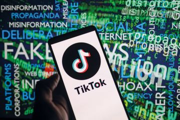 TikTok icon logo displayed on a smartphone with disinformation on screen  in the background to illustrate Students are ‘learning’ about Israel-Hamas from TikTok. We must step up