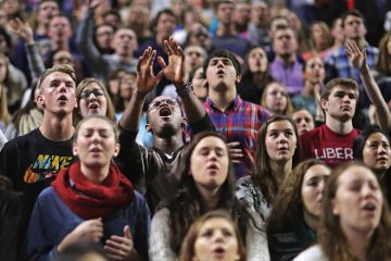 Large crowd of students singing for Liberty after Falwell struggling with diversity