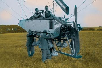 Man with a megaphone on an airship being carried by two men as a metaphor for We must be free to soar over disciplinary borders