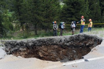 Hikers looking at a sinkhole that measures 25x20 feet and approximately 50-60 feet deep in Colorado Hikers looking at a sinkhole that measures 25x20 feet and approximately 50-60 feet deep in Colorado to illustrate Review finds billion-dollar hole in Johns Hopkins medicine budget