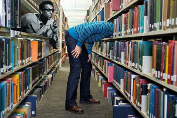 Montage of a library person with head deep in shelf and another person leaning out of a shelf Montage of a library person with head deep in shelf and another person leaning out of a shelf to illustrate Librarians need the knowledge and willpower to challenge decolonisation
