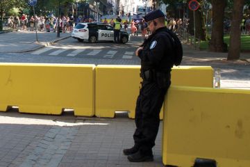Finland police on duty leaning on a barrier as a metaphor for Academics reluctant to report violent online threats to police