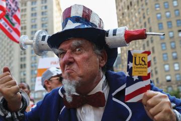 Protestor at "Freedom Rally" to protest the vaccination mandate in New York City to illustrate US campuses retreat from vaccine mandates despite Covid surge