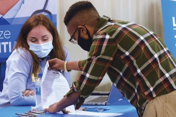 Person at a job fair as a metaphor for NIH funds cluster hiring of ethnic minority  scientists
