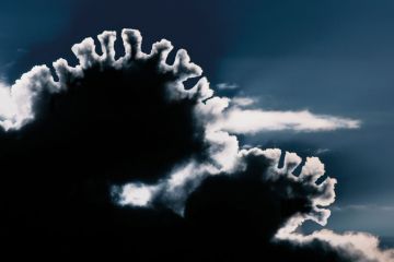 Sunlight shining through black cloud creating silver lining, East Yorkshire, UK