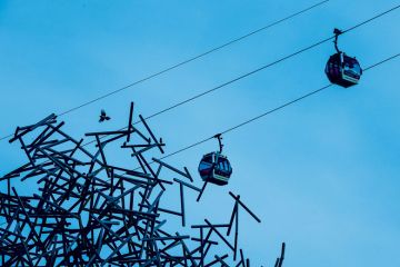 Cable cars run past the 'Quantum Cloud' sculpture to illustrate Academics need to get better at knowing when to move on