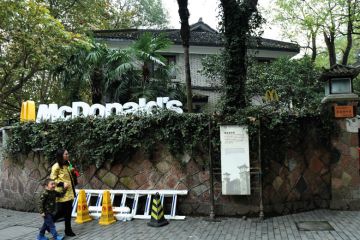 Tourists pass by a McDonald's  transformed from a house of Chiang Ching-kuo's villa to illustrate US diplomats may get research dollars to dole out in soft power bid