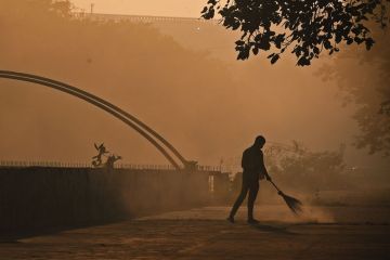 A sweeper cleans a Street early morning in Mumbai to illustrate Scholars fear push for Indian universities to teach in Hindi