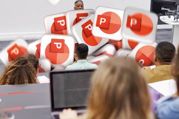 Man lectures students in lecture theatre with Power Point logos falling in front of him to illustrate PowerPoint overuse will be the death of graduate employability