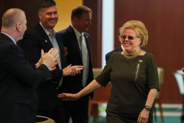 University of South Florida president elect Rhea Law enters the room to applauds and cheers as she is named the new university president as described in the article
