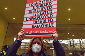 Long covid protester stand outside the Covid-19 Inquiry Hearing Centre to illustrate Study highlights academia’s ‘exhaustion economy’