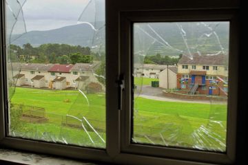 Urban decay UK view through a smashed window to illustrate Researching violence on your own turf can be a slap in the face