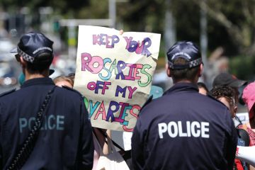 Activists held a protest against the Day of The Unborn Child at St Marys Cathedral, Sydney to illustrate Australian university makes A$1m pay off