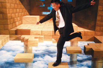 A man poses for a picture with a painting during an exhibition by the Trick Art Museum as a metaphor for Yale-NUS guarantees impossible to fulfil, academics claim