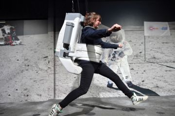 A visitor uses a space simulator during the opening of the Astronauts US bets big on entrepreneurial science exhibition to illustrate 