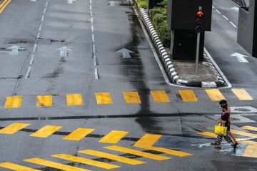 Pedestrian crossing at the intersection in downtown Kuala Lumpur to illustrate Careers advice for international students ‘misdirected’