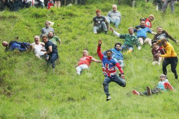 People taking part in the Cheese-Rolling downhill race in Gloucester, England to illustrate Entry rate fall creates ‘strategic uncertainty’ in English sector