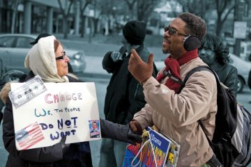 Two people having a disagreement over policies outside of the Renaissance Harborplace Hotel in Baltimore to illustrate If we are to disagree well, we must learn to balance humility and conviction