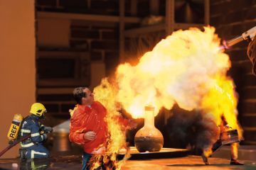 Lab technician setting fire to a ball with a hydrogen blowtorch to illustrate Can the REF really address the research environment crisis?